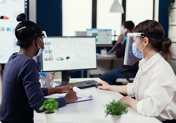 Medical team reviews data on monitors in office at US Heart and vascular