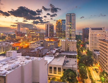 city skyline buildings at sunset with lights