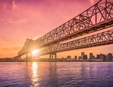 Steel bridge at sunset over water skyline