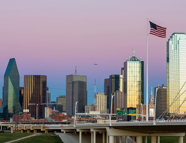 downtown skyline buildings at dusk with flag