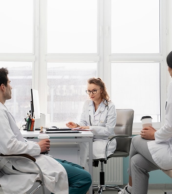 Doctor consults with patients in clinic office at US Heart and vascular