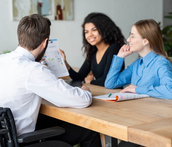 US Heart and Vascular doctor meets patients at table at hospital
