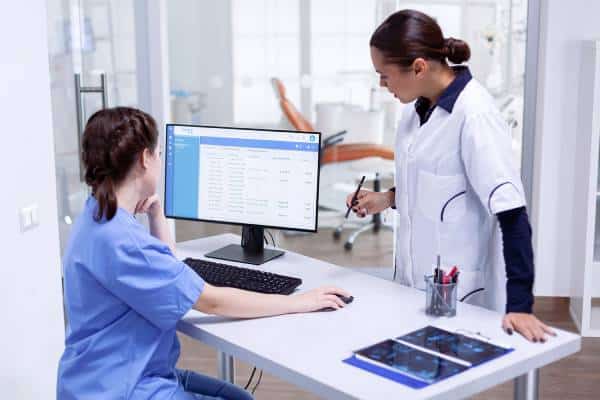 Clinicians review patient data on desktop computer at US Heart and vascular