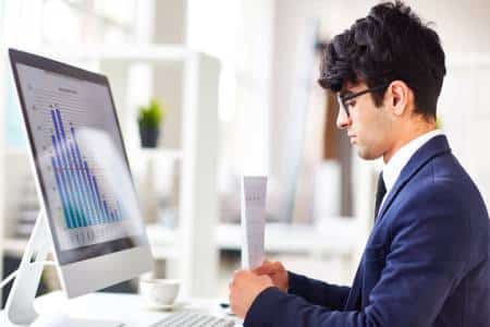 Office worker typing at desktop computer at US Heart and vascular