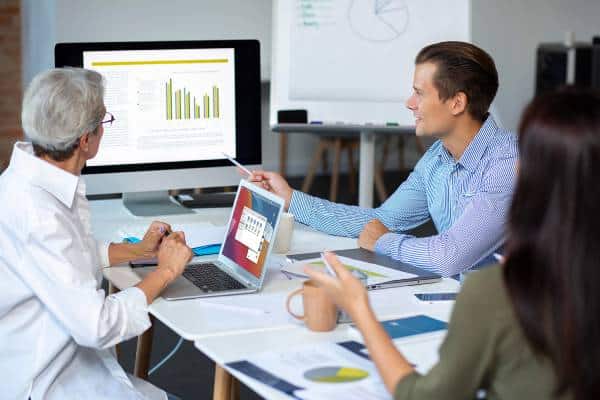 Doctors discuss charts and reports in conference room at US Heart and vascular