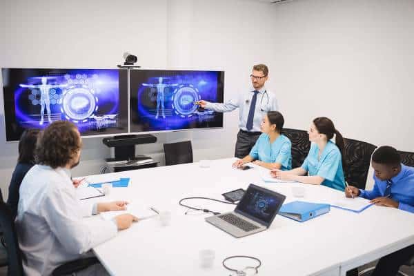 Medical team meeting with imaging on screens at US Heart and vascular