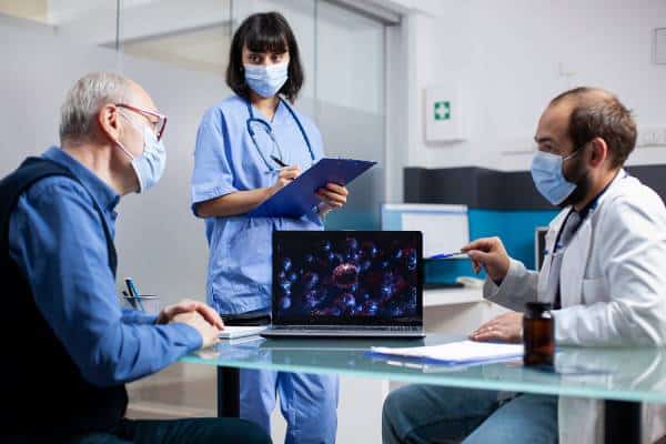 Team meeting with laptop imaging and clinician notes at US Heart and vascular