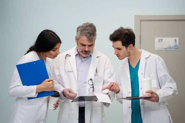 Clinicians consult over lab results on tablet at US Heart and vascular