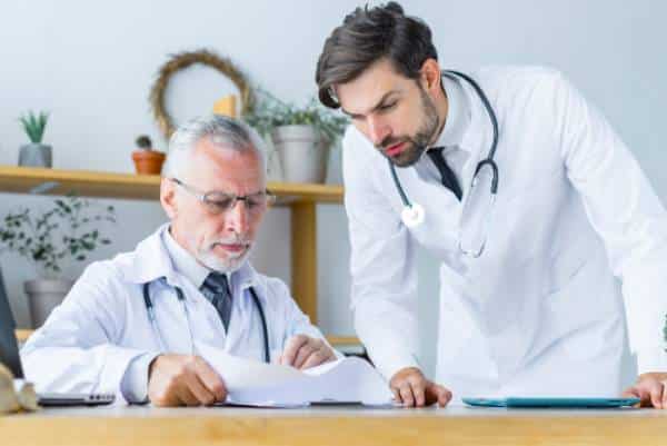 Doctors review patient notes together at US Heart and vascular