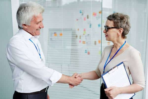Doctors shaking hands in clinic office at US Heart and vascular